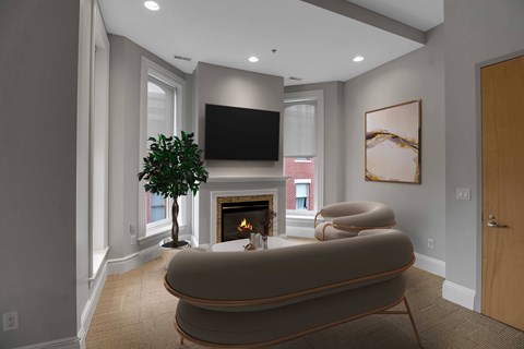A living room with a fireplace and a large couch.at The Granite Works Apartments , Buffalo, NY, 14202